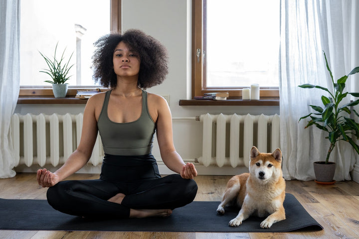 women meditating with her pet